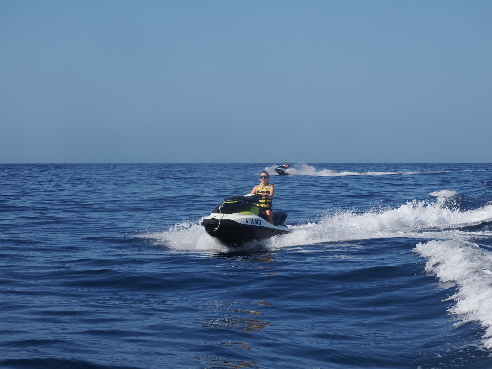 Group of jet skis running the Tenerife coastline in convoy